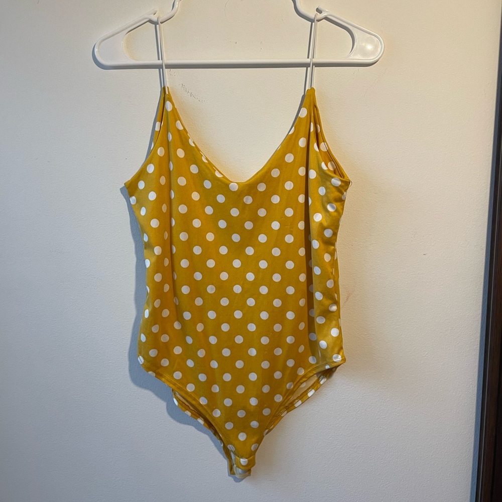 Mustard yellow and white polka dot onesie